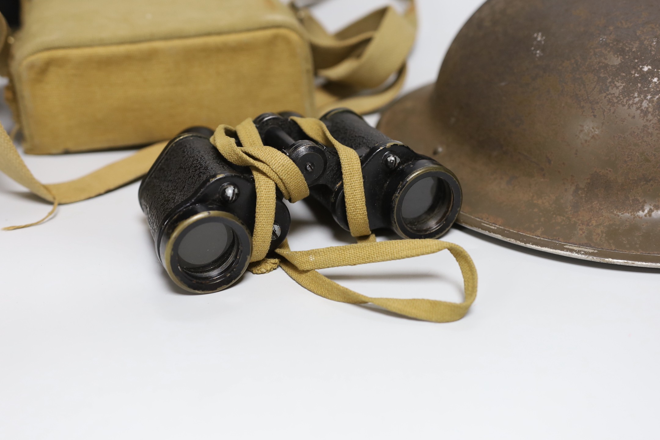 A British WWII military helmet and a pair of Kershaw military binoculars No. 326750